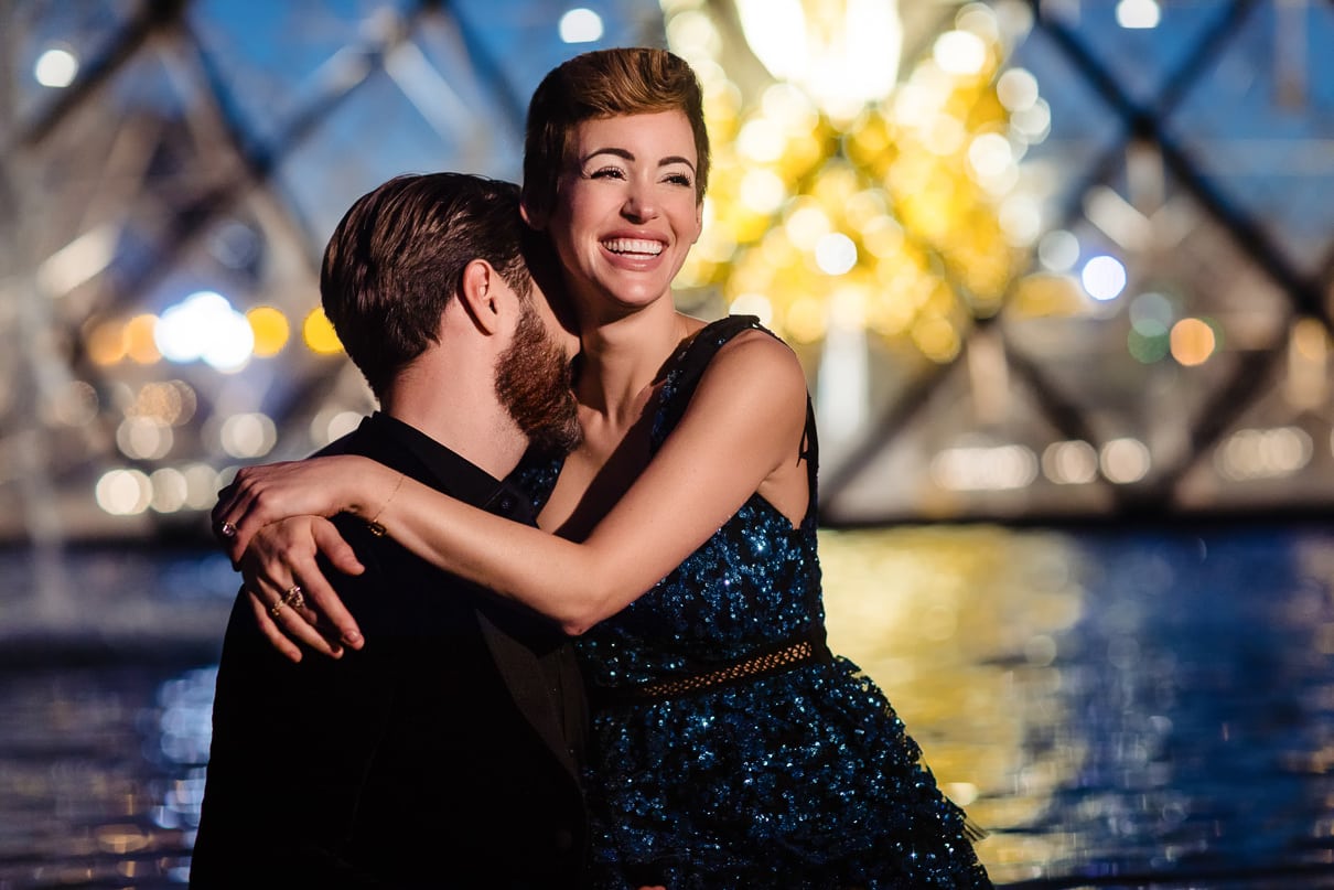 Romantic Paris engagement photos at the Louvre at night during the Blue Hour